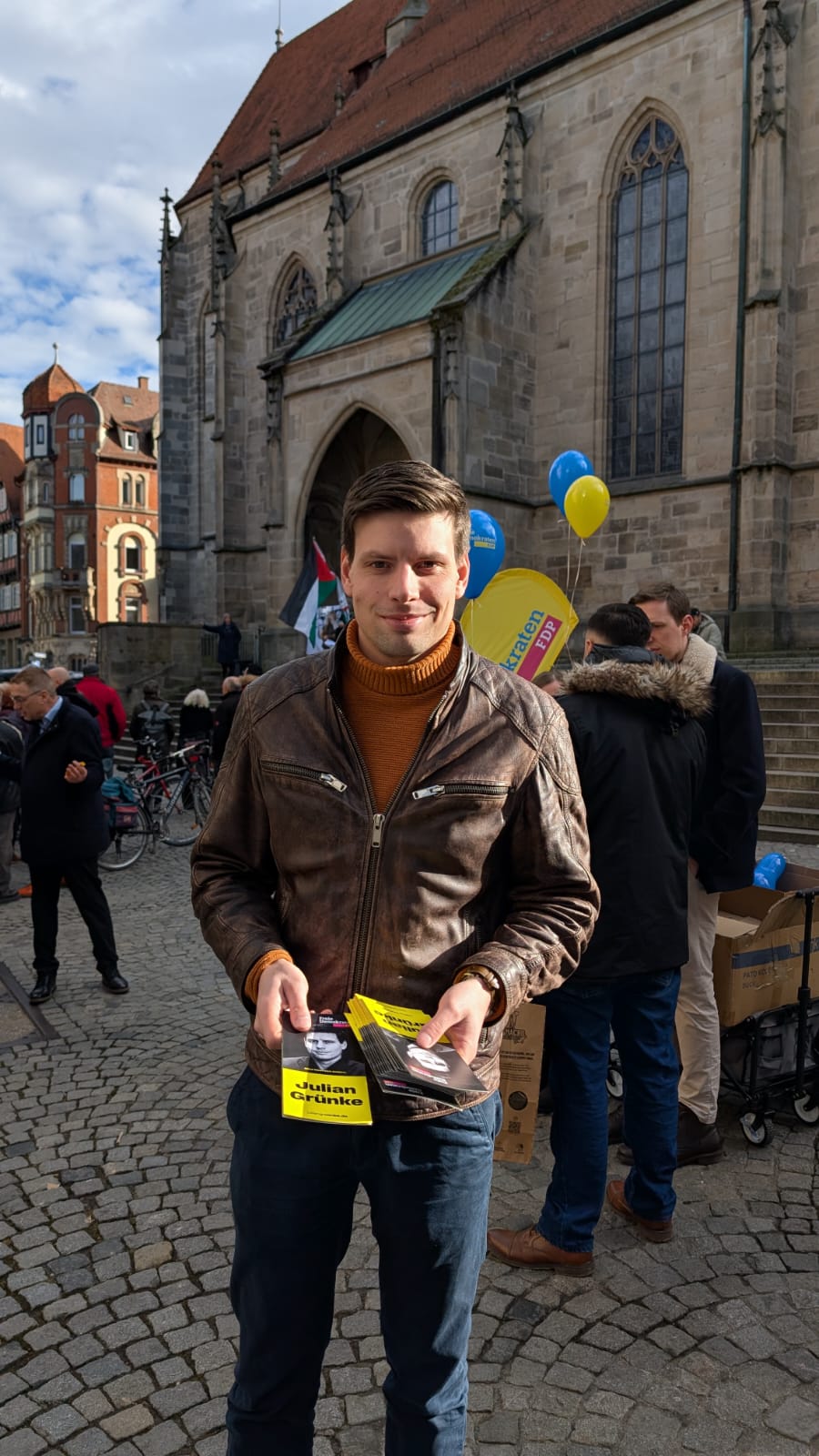 Julian Grünke verteilt Flyer an Passanden.